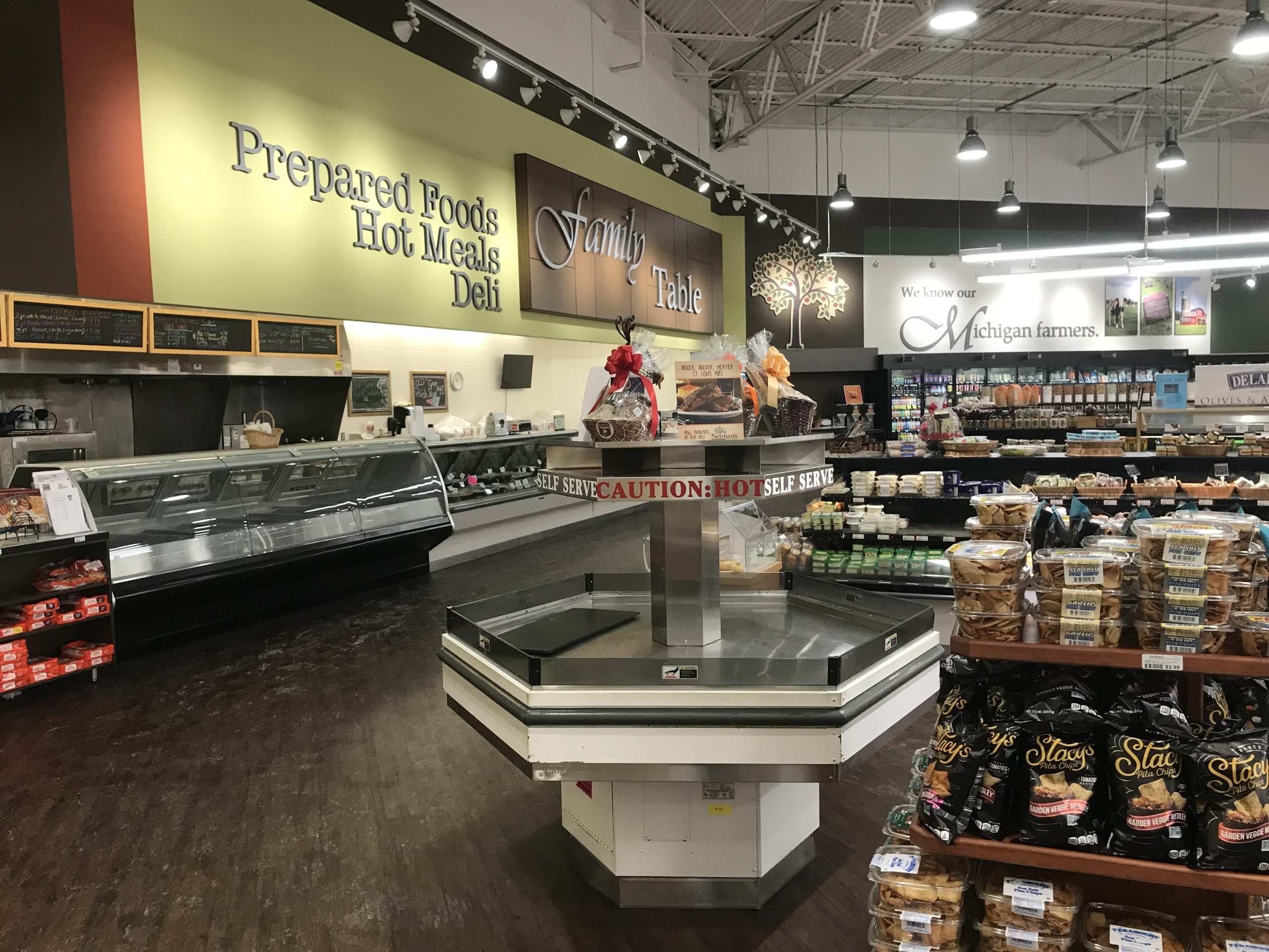 Produce, deli, prepared foods and gourmet popcorn departments highlight the shopping experience per StoreMasters floorplan